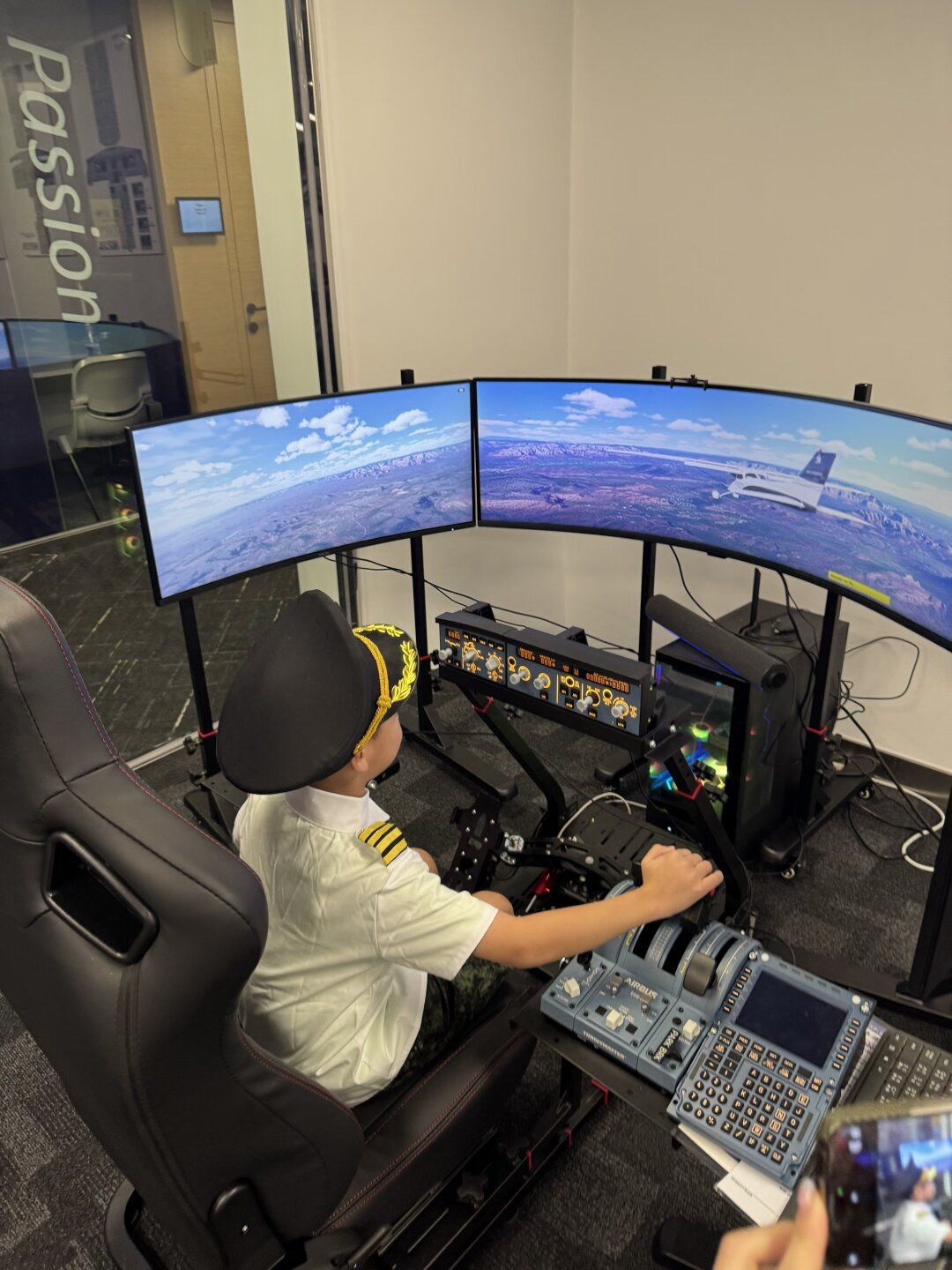 Student flying a cockpit simulator with an airline pilot